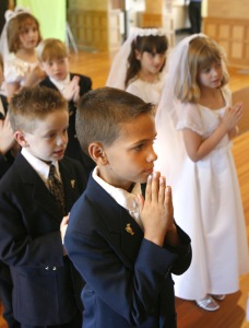 CHILDREN WAIT TO PROCESS IN FOR FIRST COMMUNION AT MARYLAND CHURCH